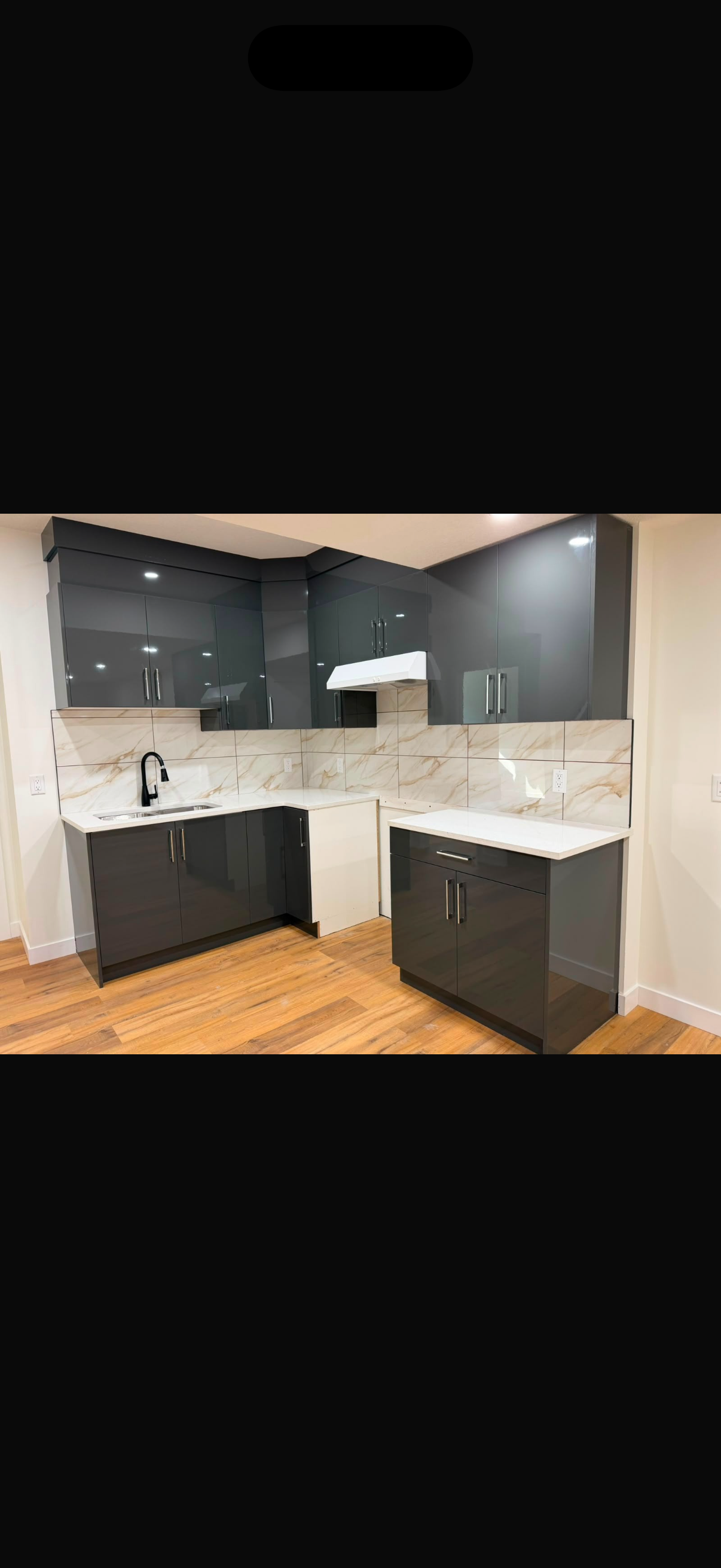 Modern kitchen with dark cabinetry and light finishes