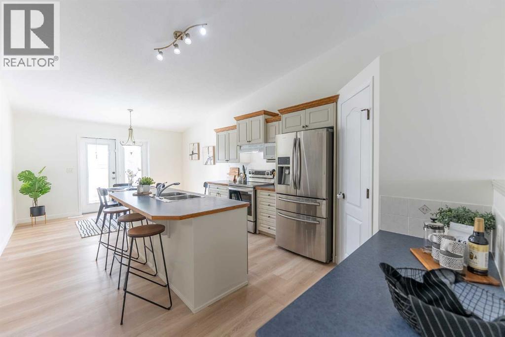 Bright finished Red Deer kitchen with new light flooring and kitchen cabinets